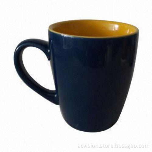 Ceramic mug with yellow color inside and blue color outside